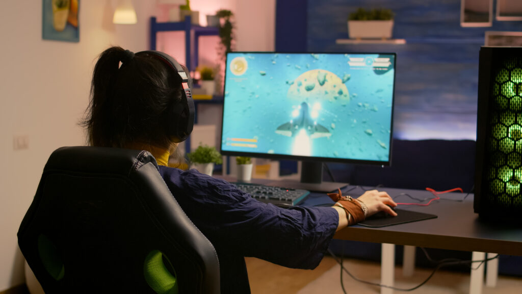 Winner gamer sitting on gaming chair at desk